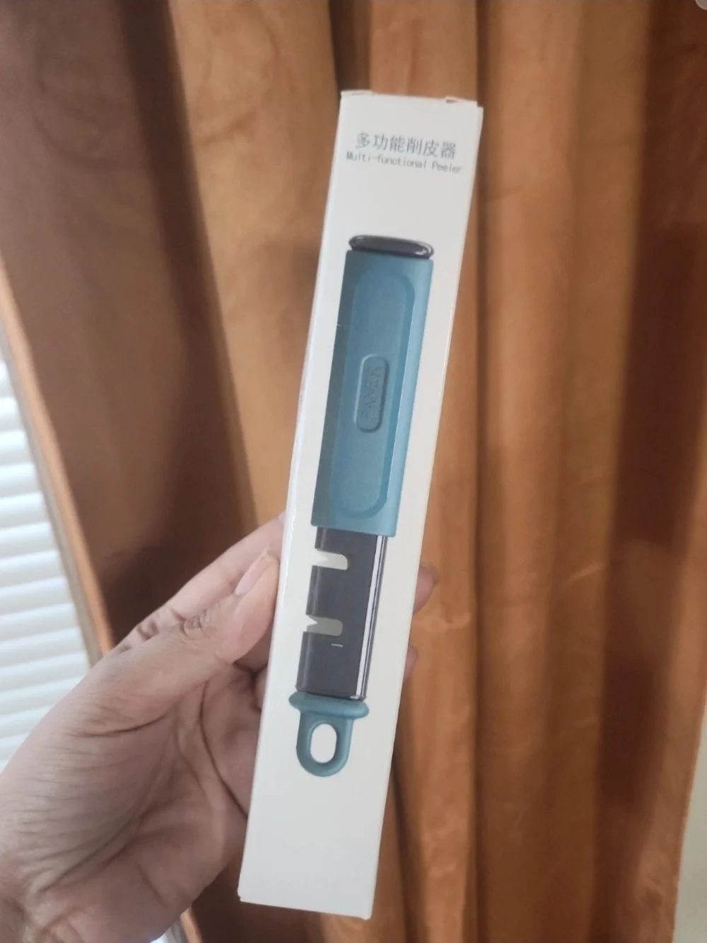 Multi-Functional Peeler with Hanging Loop